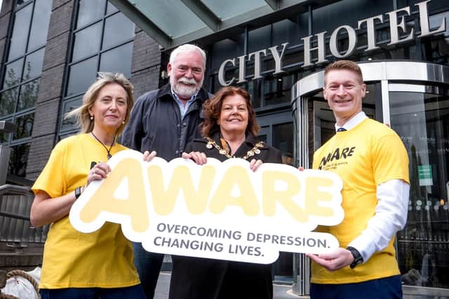AWARE NI Board Trustee Helen McDonnell, AWARE NI Chairman Bernard McAnaney, Councillor Patricia Logue, and City Hotel Manager Conor Friel launch the abseil event. Helen McDonnell and Conor Friel are set to participate in the thrilling abseil from City Hotel Derry.