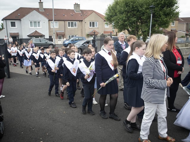 Primary 7 Confirmation pupils make their way into the church grounds on Thursday morning.