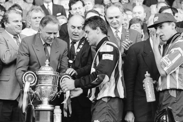 Derry captain Dermot O'Neill receives the FAI Cup from FAI President Sean Connolly as Pascal Vaudequin, Mayor of Derry John Kerr and Lord Mayor of Dublin John Gormley look on.