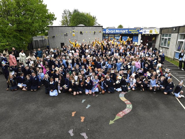Pupils and staff from Rosemount Primary School sing pictured with the Jive Aces and Deputy Major Darren Guy the school on Thursday morning. Photo: George Sweeney