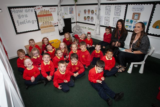 Miss Eimear Lavery pictured with her P1 class at Steelstown PS this week. On left is Miss Leah Frazer, Classroom Assistant. (Photos: Jim McCafferty Photography):.