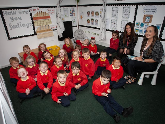 Miss Eimear Lavery pictured with her P1 class at Steelstown PS this week. On left is Miss Leah Frazer, Classroom Assistant. (Photos: Jim McCafferty Photography):.