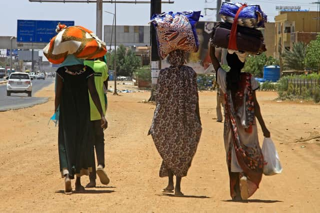 People flee from southern Khartoum on April 18, 2023 as fighting between the army and paramilitary forces led by rival generals rages for a fourth day, despite growing international calls for an end to hostilities. (Photo by AFP) (Photo by -/AFP via Getty Images)