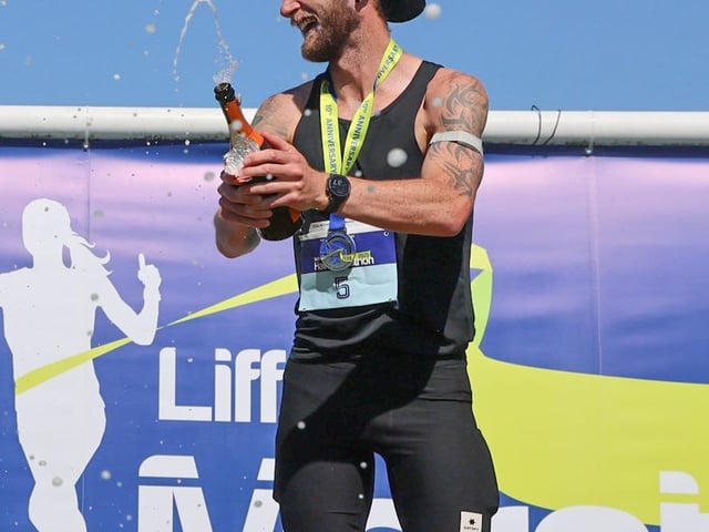 Stephen McCauley of Letterkenny AC celebrates his winning performance on the podium.