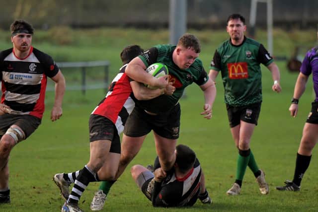 Fergus Canning of City of Derry is hauled to the ground during Saturday’s game against Crooke. Photo: George Sweeney