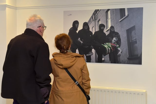 Visitors viewing an art work at the launch Square Bear’s exhibition ‘Injustice’ at the Eden Arts Centre on Monday evening last. The exhibition commemorating the 51st anniversary of Bloody Sunday runs until 1st February next.  Photo: George Sweeney. DER2305GS – 72