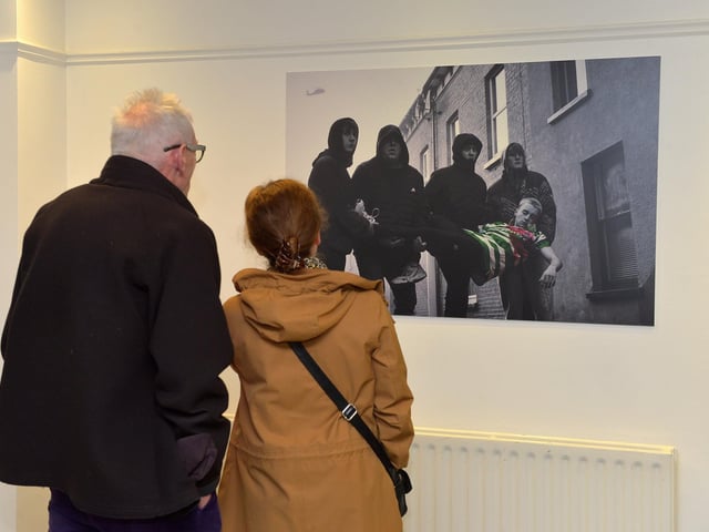 Visitors viewing an art work at the launch Square Bear’s exhibition ‘Injustice’ at the Eden Arts Centre on Monday evening last. The exhibition commemorating the 51st anniversary of Bloody Sunday runs until 1st February next.  Photo: George Sweeney. DER2305GS – 72