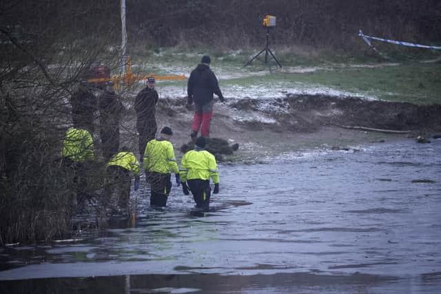 SOLIHULL, ENGLAND - DECEMBER 12: Emergency workers resume searches to determine if there was anyone else in the water on December 12, 2022 at Babbs Mill Park in Solihull, England. Four children were taken to hospital in critical condition after falling through an icy lake last night. Three of the children have since died. (Photo by Christopher Furlong/Getty Images)