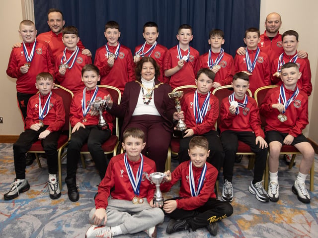 The Mayor of Derry City and Strabane District Council, Patricia Logue, pictured at the D&D Youth FA Annual Awards at the City Hotel on Friday night presents Newell Academy U-11s with the Premier League Cup, Jon Clifford Cup and the Ciaran Coyle up. Included are coaches Darren Quigley and Conor Kelly.