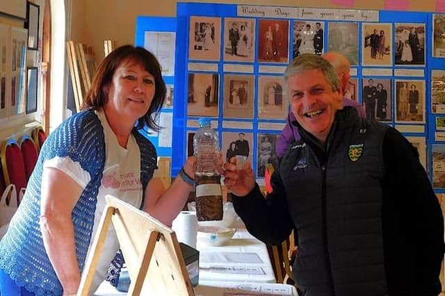 Mary Devlin provides local GP, Dr. Fogarty, with a sip of bogbine, one of her special cures.