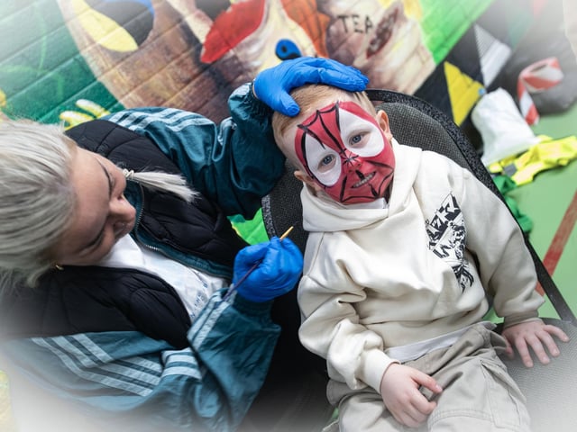 Four years old Regan Toland shows off his face paint on Saturday. : .