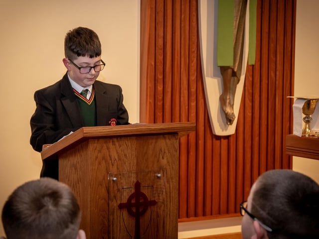 One of the young St. Joseph's students reading during 'Grandparents To School' Mass on Wednesday. : .