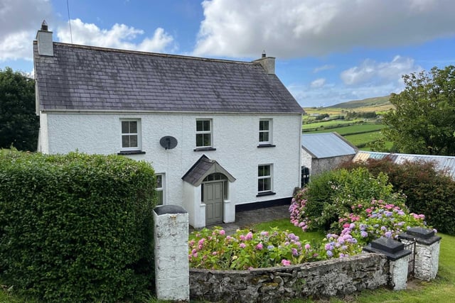 This beautifully maintained and modernised 2-storey, 3 bedroom farmhouse stands on a one acre site with Outbuildings and Sheds at Tullymore halfway between Malin Village and Malin Head only 5 minutes from Five Fingers Strand . The house which is part of an overall farm of 33 acres is being sold as a separate unit and is in excellent condition having been modernised yet retains many original features. The property, built around 80 years ago, has Bangor blue slates, pebble dash render, three spacious bedrooms, dual central heating, modern kitchen and spacious living room.