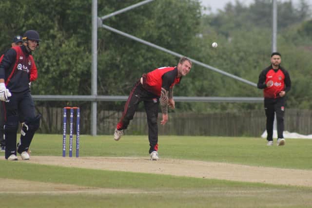 John Mooney bowling in Sunday's National Cup match between Strabane and Derriaghy. (Photo: Lawrence Moore)