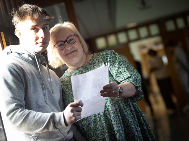Caolan McGill and his mum Ann Marie check results on Thursday morning.