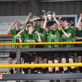 VICTORIOUS!!!!. . . St. Joseph’s Boys School captain Shea McGinley proudly lifts aloft the trophy on Friday. (Photos: Jim McCafferty Photography)