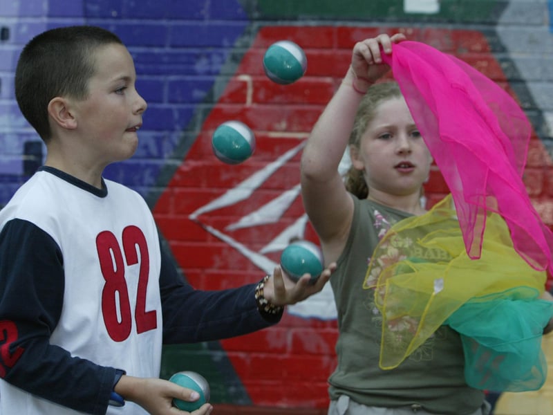 Adam McGinley and Orla McGurn practice their circus skills prior to todays performance at Melvin Hall in Strabane at 3pm. A group of local children participated iin a week long circus workshop organised and funded by Strabane District Council. (2108JB02):Derry youngsters enjoying summer in August 2003
