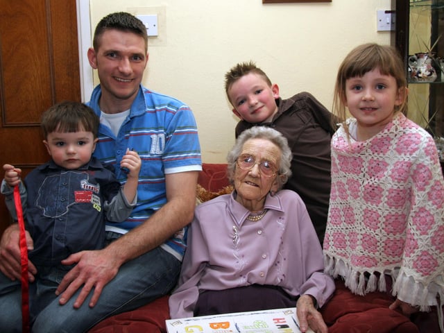 Elizabeth smiles for the camera with her grandchildren on the occasion of her 90th birthday 0041JML : Parties and celebrations April 2006: Elizabeth Doherty.