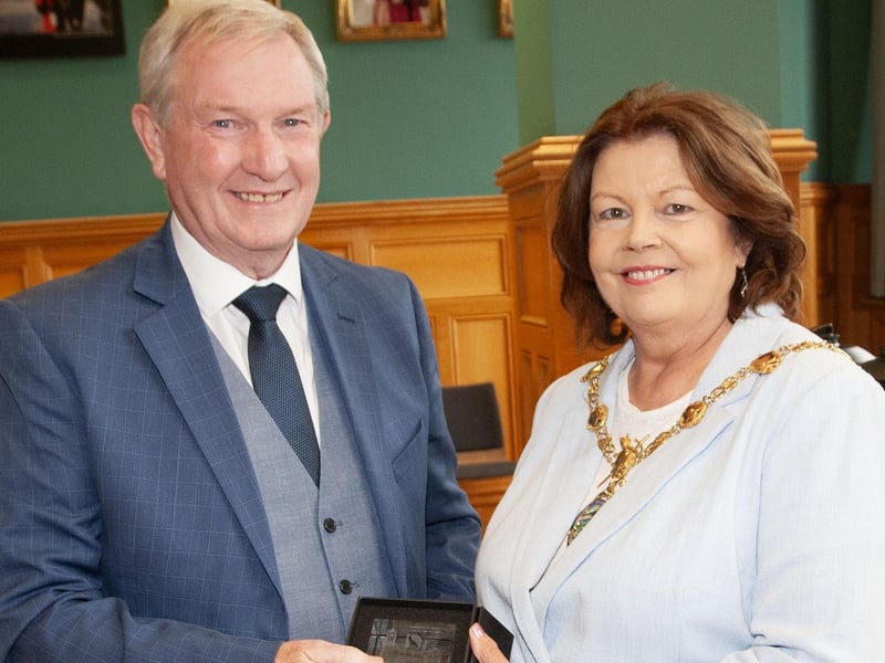 Retiring driver Jim Kelly receiving his award from the Mayor, Patricia Logue.