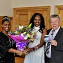 Ryungo O’Connor and her husband, popular singer John O’Connor, present Mayor Lilian Seenoi Barr with a bouquet of flowers and a copy of John’s latest collection of classic songs on CD ‘Down Memory Lane My Way’ during a reception at the Guildhall. Photo: George Sweeney