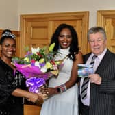 Ryungo O’Connor and her husband, popular singer John O’Connor, present Mayor Lilian Seenoi Barr with a bouquet of flowers and a copy of John’s latest collection of classic songs on CD ‘Down Memory Lane My Way’ during a reception at the Guildhall. Photo: George Sweeney