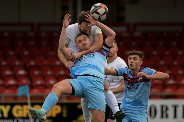 Adam McCallum of Ards grapples with Institute’s Mikhail Kenneddy. Photograph: George Sweeney