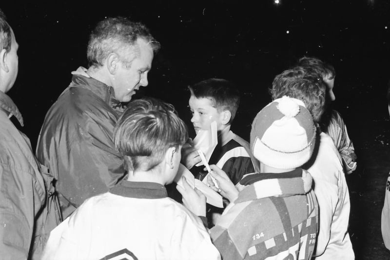 Manchester City player-manager Peter Reid signs autographs for young fans during the club's visit to the Brandywell.
