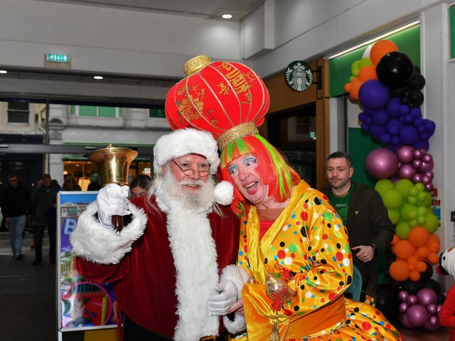 Santa poses with the Widow Twankey (Conal Gallan), from the  Aladdin pantomime, at the Richmomd Shopping Centre on Saturday morning. Photo: George Sweeney