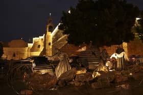 An installation depicting the nativity of Christ with a figure "symbolizing baby Jesus lying in his manger amid rubble", in reference to Gaza, is displayed in front of the Church of the Nativity in the city of Bethlehem in the occupied West Bank on December 23, 2023. (Photo by HAZEM BADER / AFP) (Photo by HAZEM BADER/AFP via Getty Images)