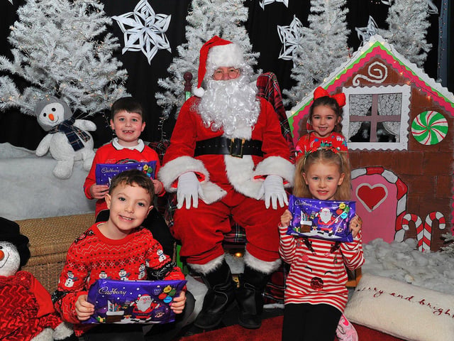 St Eithne’s Primary School P3 pupils Luke, Rogan, Esla and Laura from Miss Gallagher’s class pictured with Santa during his on Friday. Photo: George Sweeney. DER2250GS – 47
