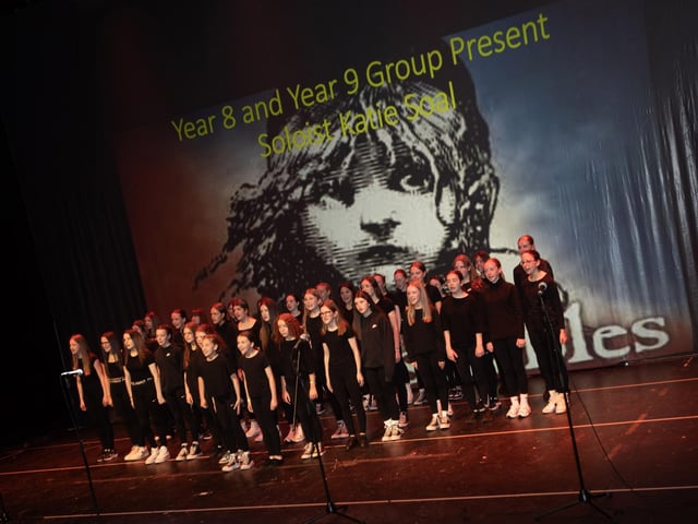 Year 8 and 9 pupils perform At the End of the Day with soloist Katie Soal at the Millennium Forum on Friday.