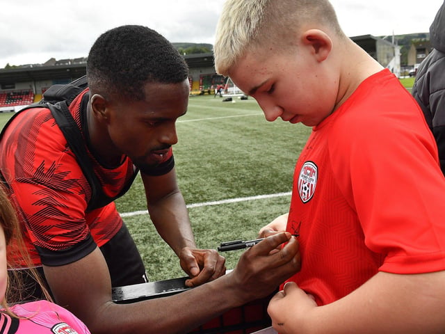 Sadou Diallo signs a shirt for a fan at the Derry City open training session on Monday morning in  Brandywell Stadium. The event was organised at part of the Gasyard Feile.  Photo: George Sweeney / Derry Journal