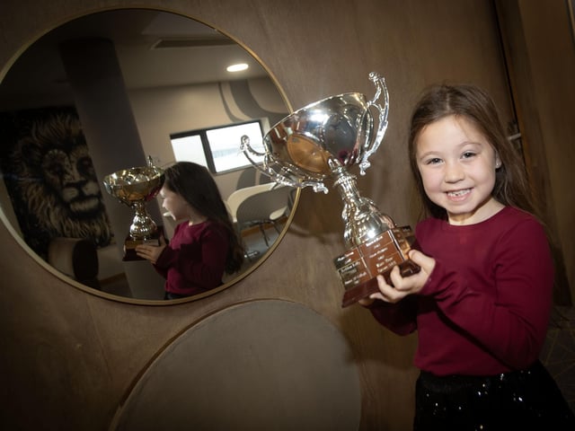 One of the young winners proudly displaying her trophy on Saturday.