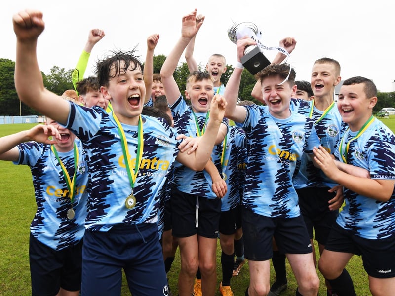 The Magherafelt Sky Blues team celebrate after lifting the O'Neills Foyle Cup Under-13's trophy at Wilton Park on Friday. (Photo: Keith Moore)