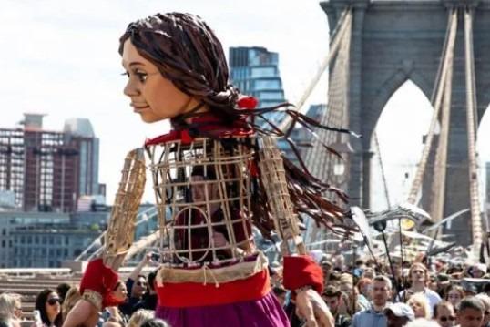 At 3pm Little Amal will walk from Ebrington across the Peace Bridge to Guildhall Square.
