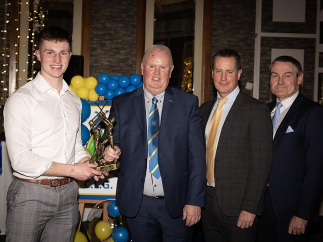 Conor Gartland, Senior Hurling Player of the Year 2024, receives his trophy from Liam Gallagher, Club Chair. Included on right are Cormac Hartnett, County Board Hurling Officer and Ciaran McLaughlin, former Ulster GAA President. (Photo: Jim McCafferty)