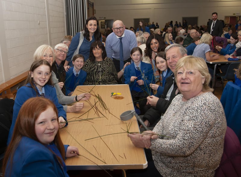Teaching staff, pupils and their grandparents getting ready to make some St. Brigid’s crosses.