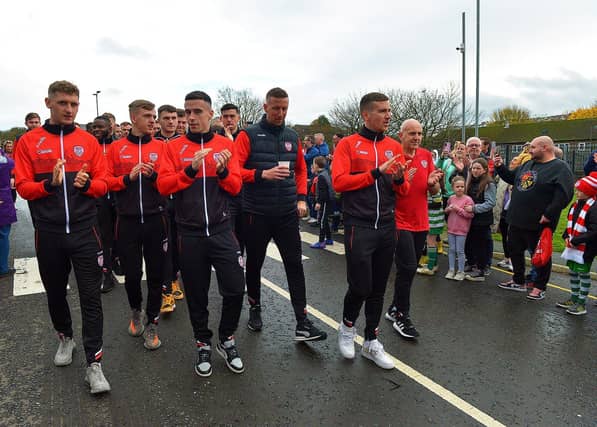 Derry City players and staff greet fans gathered at Brandywell Stadium on Saturday morning prior to their departure for Dublin ahead of tomorrow’s FAI Cup Final against Shelbourne. George Sweeney. DER2244GS – 46