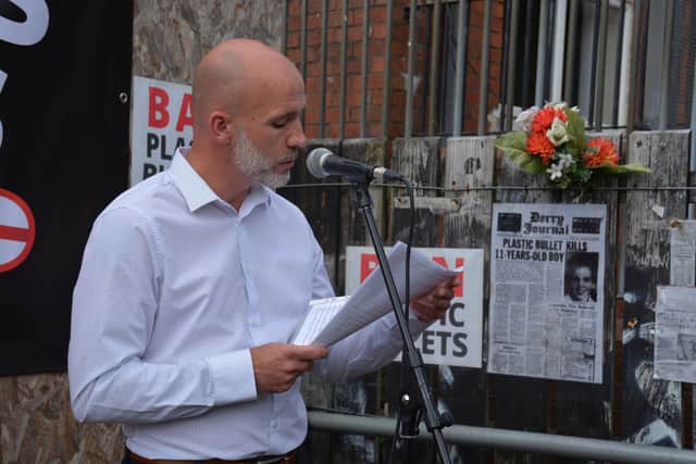 Emmett McConomy speaking at a memorial event for his brother Stephen on Fahan Street.