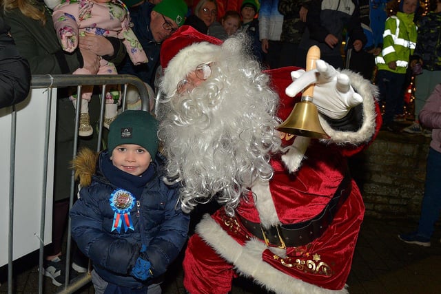 Santa with Oisin McGowan at the Christmas tree lights switch on in Buncrana on Friday evening last. Photo: George Sweeney. DER2247GS – 96