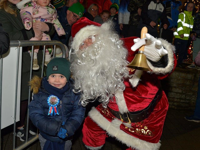 Santa with Oisin McGowan at the Christmas tree lights switch on in Buncrana on Friday evening last. Photo: George Sweeney. DER2247GS – 96