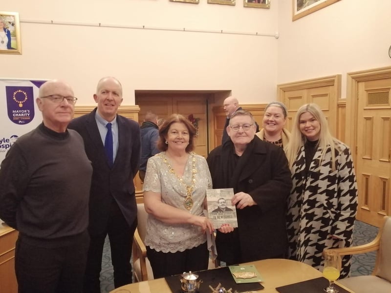 The Mayor Patricia Logue receiving a copy of Tony Hassan's memoir 'From Old Streets to New Homes' in December.