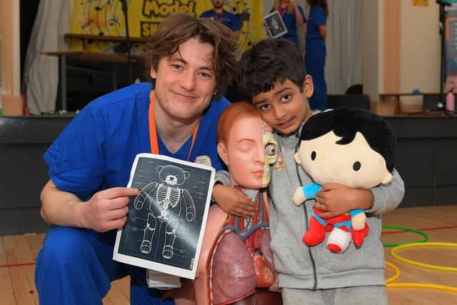 Ulster University medical student Christian Bennison pictured with a pupil at the Teddy Bear Hospital event held in the Model Primary on Wednesday morning. Photo: George Sweeney
