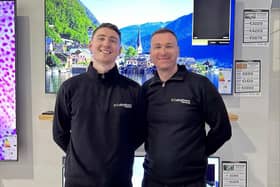 Callaghan's Electrical owner Dermot, with Aidan, in front of the 65” TV  they are raffling off.