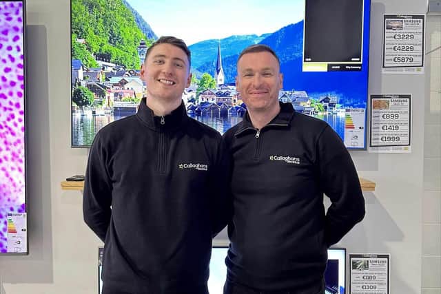 Callaghan's Electrical owner Dermot, with Aidan, in front of the 65” TV they are raffling off.