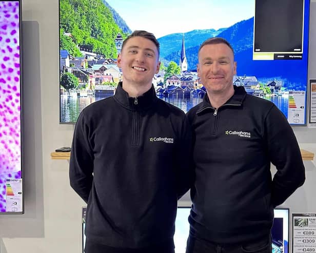 Callaghan's Electrical owner Dermot, with Aidan, in front of the 65” TV  they are raffling off.