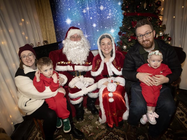 One of the many families getting a photo and collecting a present from Santa on Saturday at Derry Credit Union. : .