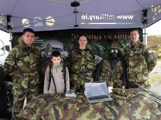 Two young lads pictured with members of the Defence Forces at the Emergency Services Showcase held at Fort Dunree, Inishowen, on Sunday. The event was organised by the members and volunteers of the Desertegney and Dunree Foróige Club. Photo: George Sweeney