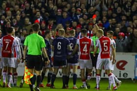 Carl Winchester is shown a straight red card by referee Gavin Colfer at the start of the second half for a challenge on Mason Melia. Photograph by Kevin Moore.
