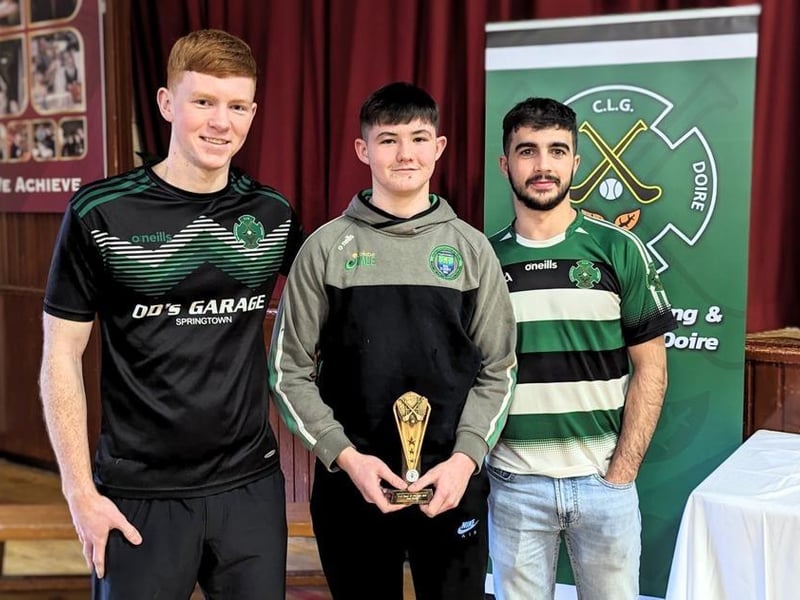 Daniel Doherty and Keelan Doherty present Joe Bryson with the U15 Hurlers player of the year award.